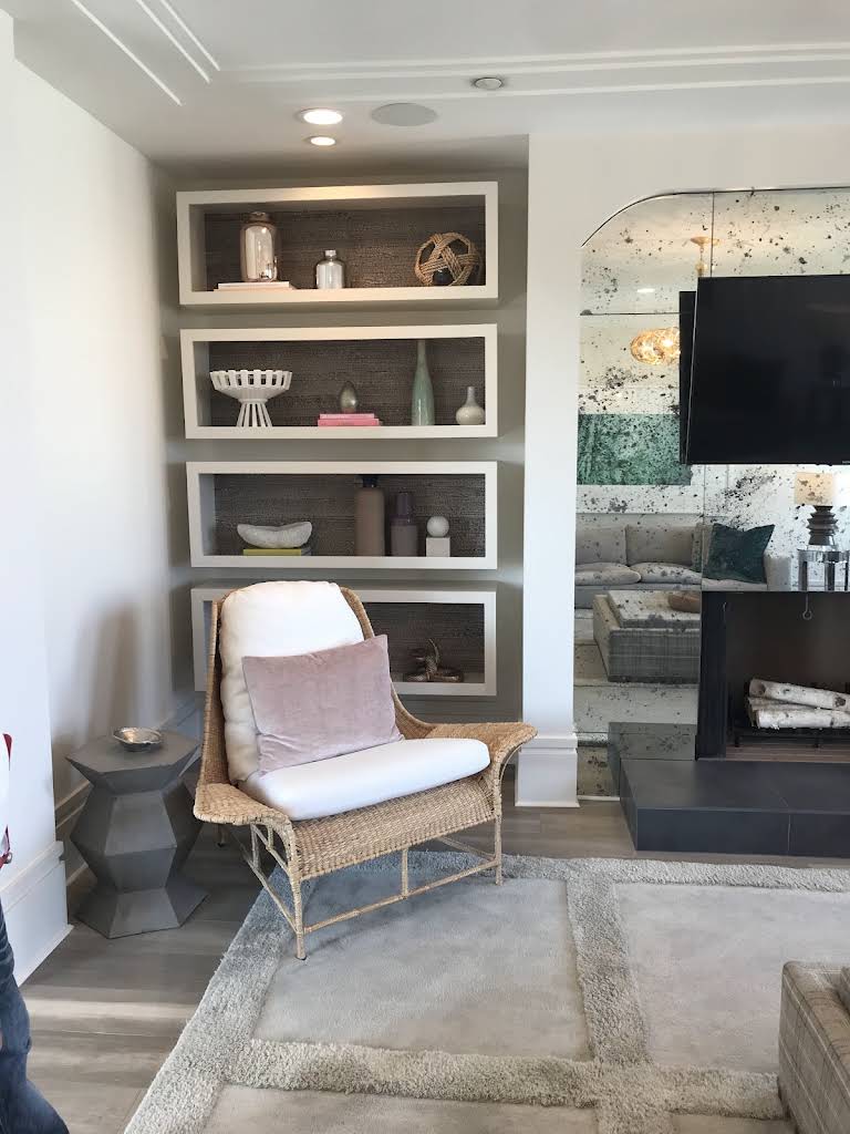 Built-in bookcase beside a fireplace