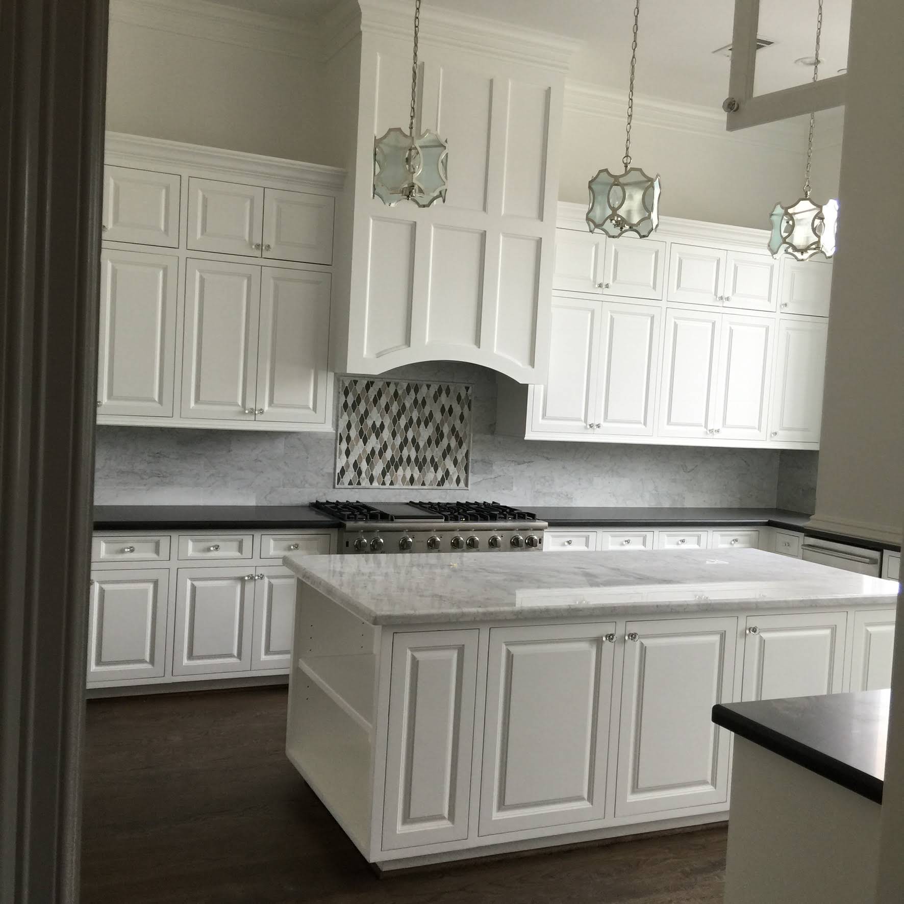 White kitchen cabinets extending to the ceiling