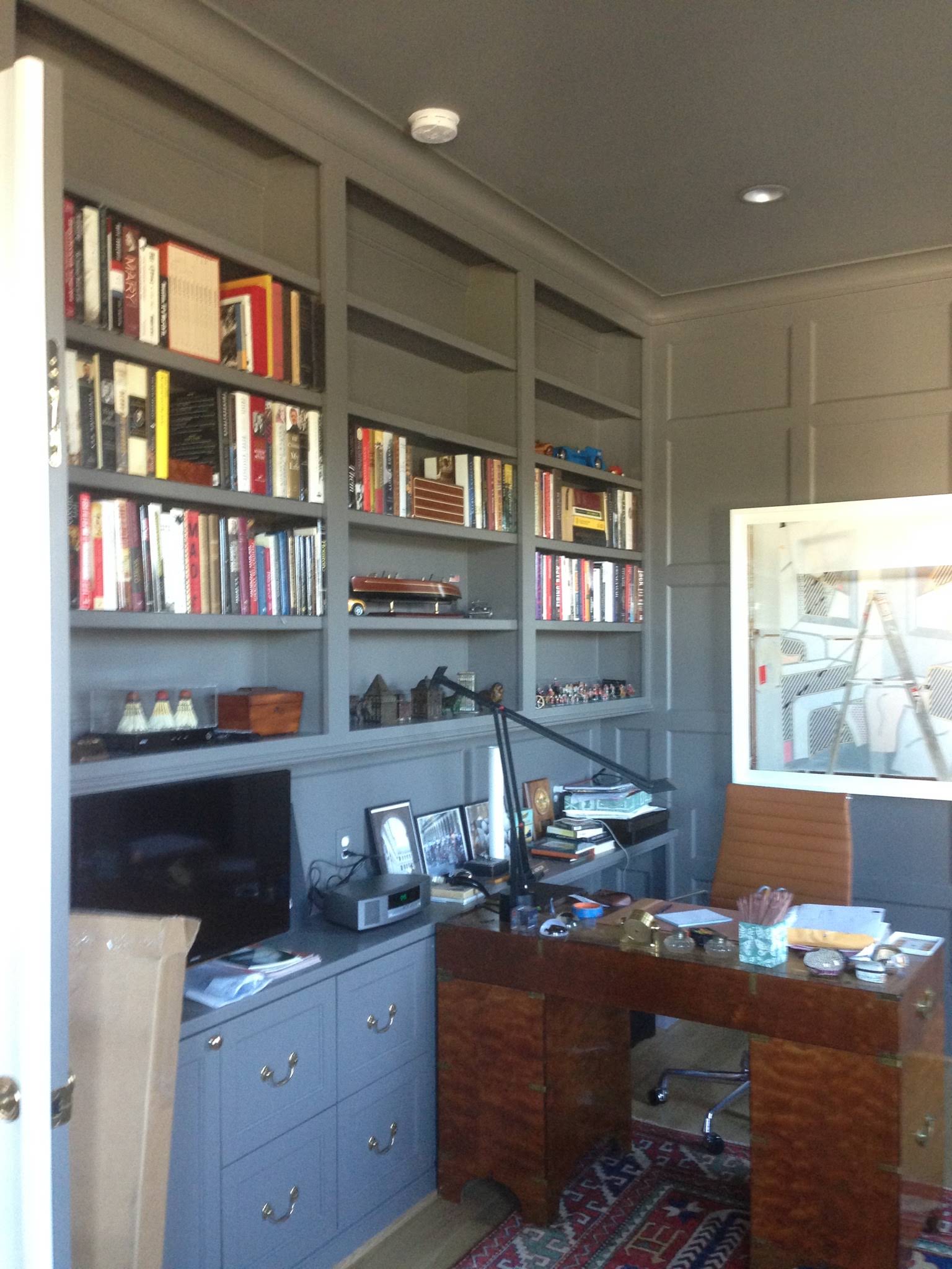 Library, drawers and desk beside a window
