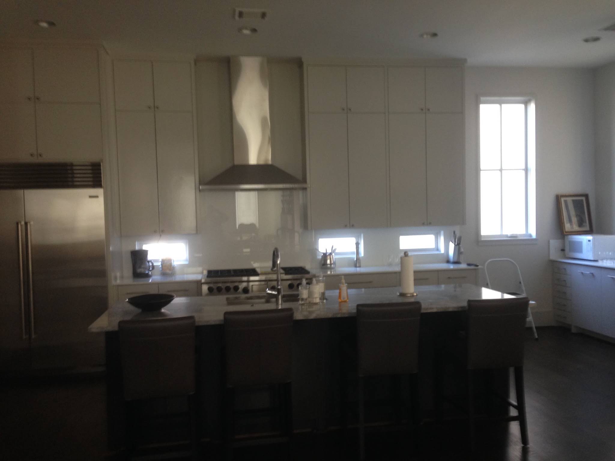 White kitchen with a metal hood