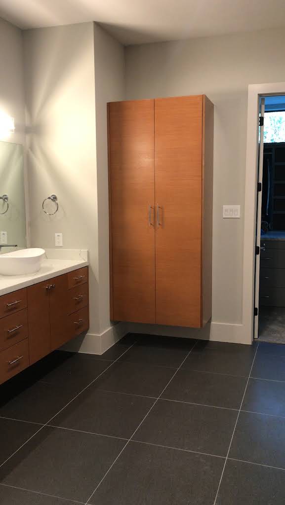 Tall bathroom storage beside a vanity